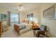 Bright bedroom with wood flooring and comfortable seating area at 6074 E Los Reales Dr, Carefree, AZ 85377