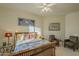 Spacious bedroom with wood flooring, ceiling fan, and two comfy armchairs at 6074 E Los Reales Dr, Carefree, AZ 85377