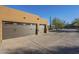 Attached three-car garage with modern doors at 6074 E Los Reales Dr, Carefree, AZ 85377