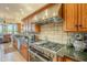 Modern kitchen features stainless steel appliances and granite countertops at 6074 E Los Reales Dr, Carefree, AZ 85377