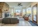 Spacious living room with stone fireplace and large windows at 6074 E Los Reales Dr, Carefree, AZ 85377
