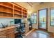 Home office with built-in desk and shelves, plus backyard access at 6074 E Los Reales Dr, Carefree, AZ 85377
