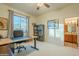 Bright office space with a large desk, bookcase, and views of the backyard at 6074 E Los Reales Dr, Carefree, AZ 85377