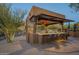 Covered outdoor bar with seating and string lights at 6074 E Los Reales Dr, Carefree, AZ 85377