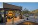 Covered patio with fireplace and seating area at 6074 E Los Reales Dr, Carefree, AZ 85377
