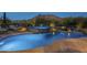 Inviting pool and spa with mountain views at dusk at 6074 E Los Reales Dr, Carefree, AZ 85377