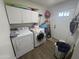Functional laundry room with washer, dryer, and overhead cabinets at 625 N 38Th N St, Mesa, AZ 85205