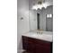 Updated bathroom with modern vanity, updated fixtures, and a large mirror at 7146 W Globe Ave, Phoenix, AZ 85043