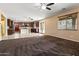 Open kitchen with dark brown cabinets, an island, and tile flooring at 12029 W Overlin Ln, Avondale, AZ 85323