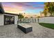 Sunset view of backyard with pool and fire pit at 1302 W Golden Ln, Phoenix, AZ 85021