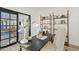 Home office with built in shelving and view into living area at 1302 W Golden Ln, Phoenix, AZ 85021
