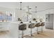 Modern white kitchen with island, stainless steel appliances, and breakfast bar at 1302 W Golden Ln, Phoenix, AZ 85021
