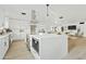 Bright white kitchen with island, stainless steel appliances, and open floor plan at 1302 W Golden Ln, Phoenix, AZ 85021