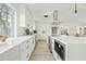 Modern white kitchen with large island and stainless steel appliances at 1302 W Golden Ln, Phoenix, AZ 85021