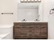 Bathroom vanity features a wood cabinet, white countertop, and a large mirror at 15221 N Clubgate Dr # 1110, Scottsdale, AZ 85254