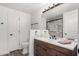 Bathroom with wood vanity, shower, toilet, and a large framed mirror at 15221 N Clubgate Dr # 1110, Scottsdale, AZ 85254