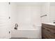 Bathroom featuring a soaking tub, modern fixtures, and sleek wood-look vanity at 15221 N Clubgate Dr # 1110, Scottsdale, AZ 85254