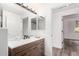 Bathroom with a wood vanity, shower, and a view into another room at 15221 N Clubgate Dr # 1110, Scottsdale, AZ 85254