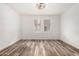 Bright bedroom with natural light, wood-look floors, and modern ceiling fan at 15221 N Clubgate Dr # 1110, Scottsdale, AZ 85254