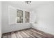 Bright bedroom with wood floors, plantation shutters, and a modern light fixture at 15221 N Clubgate Dr # 1110, Scottsdale, AZ 85254