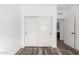 Bedroom closet with wood floors and sliding doors with black hardware at 15221 N Clubgate Dr # 1110, Scottsdale, AZ 85254