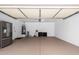 Spacious garage with epoxy flooring, refrigerator, and updated water heater providing ample room for storage at 15221 N Clubgate Dr # 1110, Scottsdale, AZ 85254