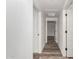 Hallway with doors leading to various rooms and wood-look flooring throughout the home at 15221 N Clubgate Dr # 1110, Scottsdale, AZ 85254