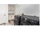 Laundry room with modern washer and dryer set and ample cabinet space at 15221 N Clubgate Dr # 1110, Scottsdale, AZ 85254