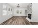 Well-lit living room showcasing stylish fireplace with custom tile surround and elegant wood-look flooring at 15221 N Clubgate Dr # 1110, Scottsdale, AZ 85254