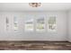 Bright living room featuring plantation shutters, wood-look floors, and natural light at 15221 N Clubgate Dr # 1110, Scottsdale, AZ 85254