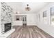 Spacious living room with open floor plan, modern fireplace, wood floors, and plantation shutters at 15221 N Clubgate Dr # 1110, Scottsdale, AZ 85254