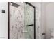 Walk-in shower features sleek glass doors and decorative marble-style tile surround at 15221 N Clubgate Dr # 1110, Scottsdale, AZ 85254