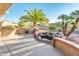 Landscaped backyard with grill and water feature at 19425 N Guardian Ln, Surprise, AZ 85387
