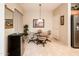 Bright breakfast nook features a glass table and four chairs at 19425 N Guardian Ln, Surprise, AZ 85387