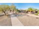 A paved pathway meanders through the neighborhood, offering views of homes and landscaping at 19425 N Guardian Ln, Surprise, AZ 85387
