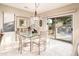 Elegant dining area with glass-top table and view to backyard at 19425 N Guardian Ln, Surprise, AZ 85387