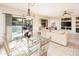 Bright dining area with glass table and chairs, view to backyard at 19425 N Guardian Ln, Surprise, AZ 85387