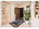 Bright entryway with tile flooring, a large plant, and wine storage at 19425 N Guardian Ln, Surprise, AZ 85387