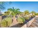 Landscaped front yard with palm trees and drought-tolerant plants at 19425 N Guardian Ln, Surprise, AZ 85387