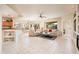 Open living room and kitchen with tile floors and neutral decor at 19425 N Guardian Ln, Surprise, AZ 85387