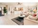 Open living room and kitchen with tile floors and neutral decor at 19425 N Guardian Ln, Surprise, AZ 85387