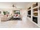 Spacious living room with tile floors, fireplace, and built-in shelving at 19425 N Guardian Ln, Surprise, AZ 85387