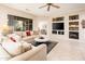 Spacious living room with tile floors, fireplace, and built-in shelving at 19425 N Guardian Ln, Surprise, AZ 85387