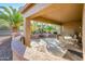 Covered patio with seating and water feature at 19425 N Guardian Ln, Surprise, AZ 85387