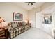Cozy sitting room with plaid sofa and ceiling fan at 19425 N Guardian Ln, Surprise, AZ 85387