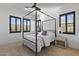 Serene bedroom features a four-poster bed, neutral color palette, and natural light from shuttered windows at 19702 E Melissa Pl, Queen Creek, AZ 85142