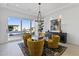 Modern dining area features stylish yellow chairs, a sleek black console, and sliding glass doors to the pool at 19702 E Melissa Pl, Queen Creek, AZ 85142