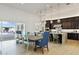 A spacious modern kitchen seamlessly connects to the dining area and overlooks the outdoor pool at 19702 E Melissa Pl, Queen Creek, AZ 85142