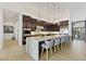 Gourmet kitchen boasting custom cabinets, modern appliances, and a large marble island with seating at 19702 E Melissa Pl, Queen Creek, AZ 85142