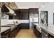 Contemporary kitchen with granite countertops, stainless steel appliances and sleek, dark-toned cabinetry at 19702 E Melissa Pl, Queen Creek, AZ 85142